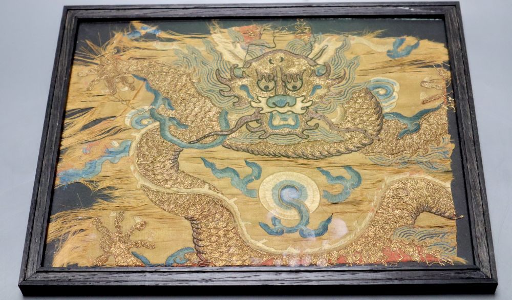 A Chinese Qing dynasty embroidered silk dragon fragment, possibly Imperial, framed, 22 x 28cm